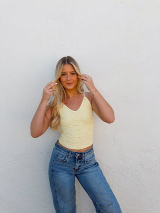 Woman modeling a yellow tank