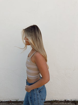 Woman modeling a sand and cream stripe tank