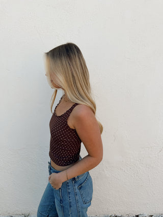 Woman modeling a brown tank and jeans
