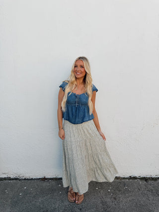 Woman standing on a white wall with a gray floor