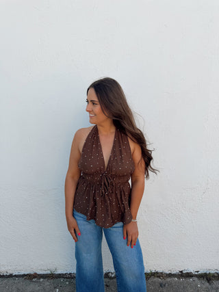 Woman modeling a chocolate and white polka dot top