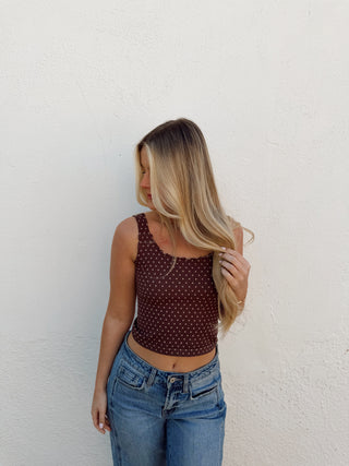 Woman modeling a brown tank and jeans