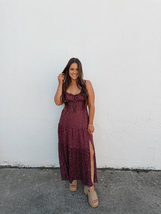 Woman modeling a plum and white polka dot dress