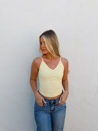 Woman modeling a yellow tank