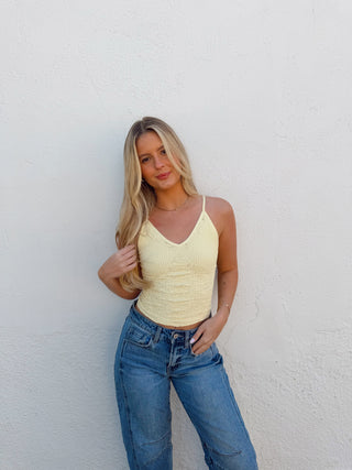 Woman modeling a yellow tank