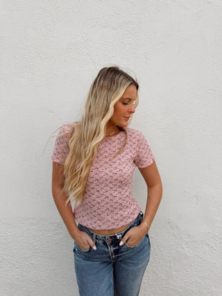 Woman modeling a pink floral top