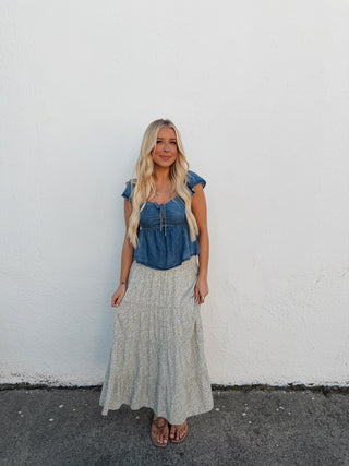 Person standing on a white wall with a gray floor