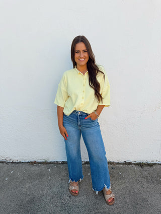 Woman modeling a yellow top