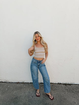 Woman modeling a sand and cream stripe tank