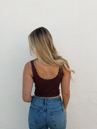 Woman modeling a brown tank and jeans