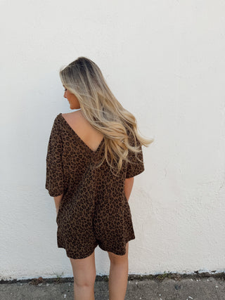 Woman modeling a leopard romper