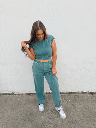 Woman modeling a teal set