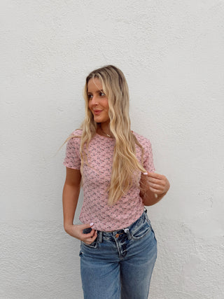 Woman modeling a pink floral top
