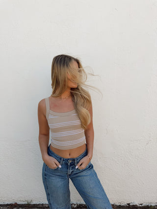 Woman modeling a sand and cream stripe tank