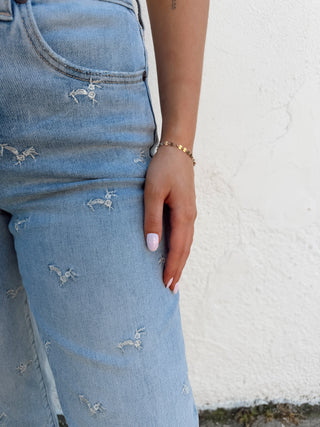 Girl modeling floral denim and a tank