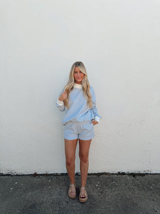 Girl modeling a blue and white striped set